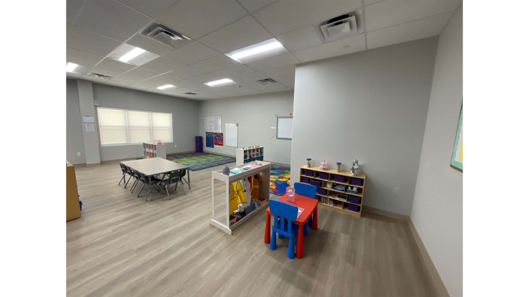 Little Texans Day Care Center interior classroom with tables, chairs and storage shelving units, Conroe, TX - Keeton Construction Services