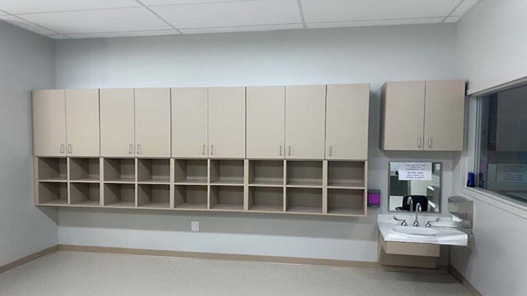 Little Texans Day Care Center interior wall with built-in cubbies, upper cabinets and a wall-mounted sink, Conroe, TX - Keeton Construction Services