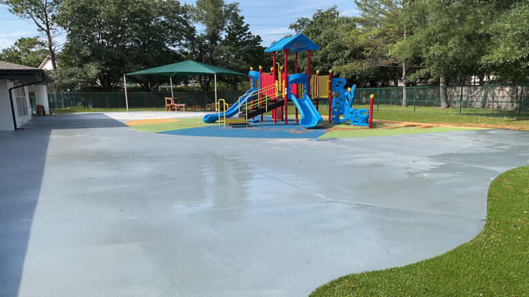 Outdoor play area with playground equipment and shade structure at Prescolaire Early Learning Academy Katy, Keeton Construction Services, Katy TX