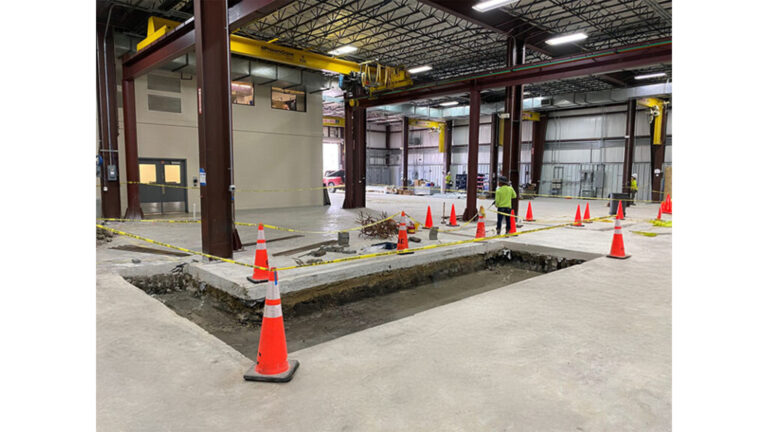 Interior floor work in progress at Oceaneering International Inc in Houston, TX, by Keeton Construction Services, with safety cones and caution tape
