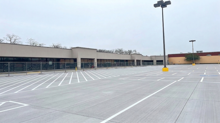 Wide view of Fairmont Retail Center exterior and parking area with light poles, Pasadena TX - Keeton Construction Services