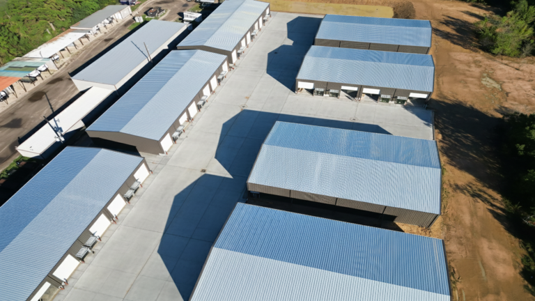 High aerial view of Spring Cypress Business Park office warehouse complex in Tomball TX showing multiple metal buildings and surrounding land, Keeton Construction Services