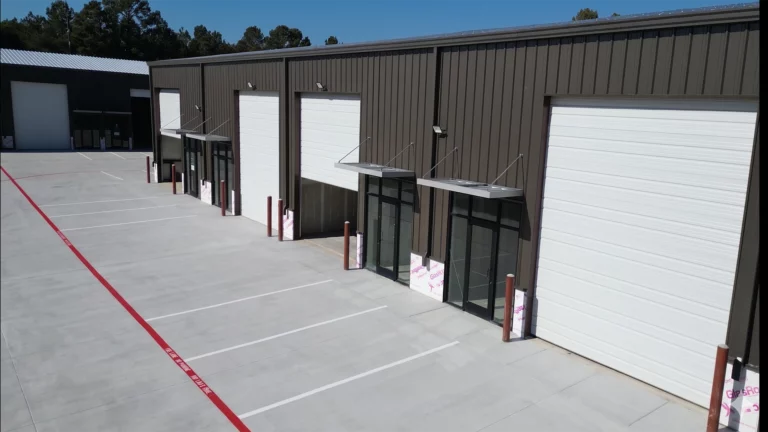Exterior facade of Spring Cypress, Business Park in Tomball TX showing overhead doors and glass entry doors on a metal building, Keeton Construction Services, Houston Warehouse Construction