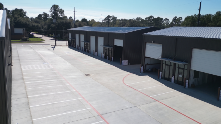 Elevated view of two metal buildings facing each other across a paved drive at Spring Cypress Business Park in Tomball TX, Keeton Construction Services