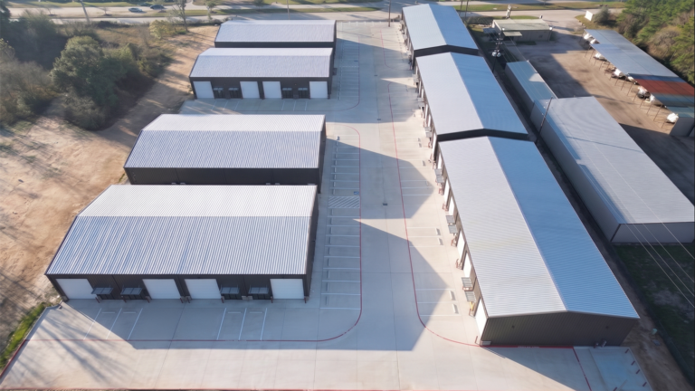 Aerial view of Spring Cypress Business Park in Tomball TX showing several metal buildings with paved drives and neighboring structures, Keeton Construction Services
