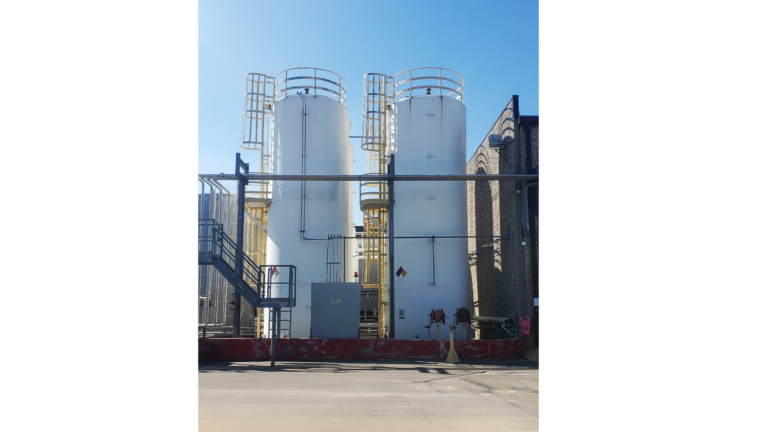 Univar Solutions Brisbane exterior view of storage tanks with yellow safety ladders and containment area by Keeton Construction Services, Houston TX
