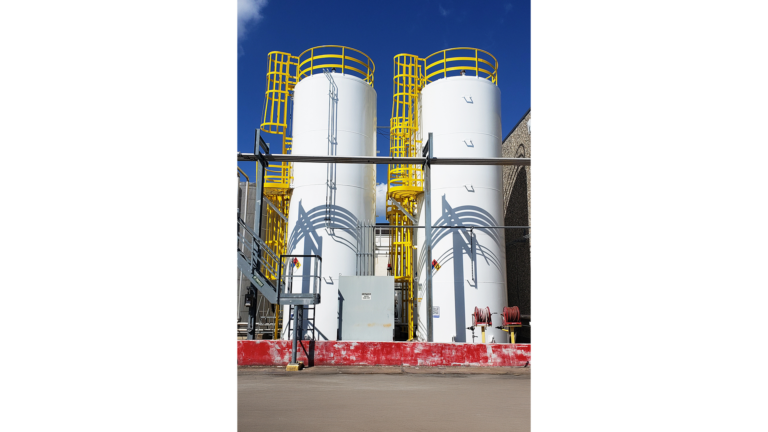 Univar Solutions Brisbane large storage tanks with yellow access ladders and safety platforms by Keeton Construction Services, Houston TX