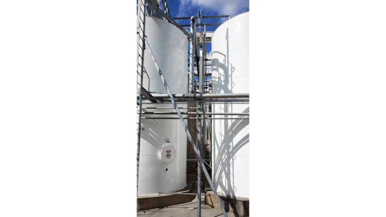 Univar Solutions Brisbane close-up of storage tanks with piping and access ladders by Keeton Construction Services, Houston TX