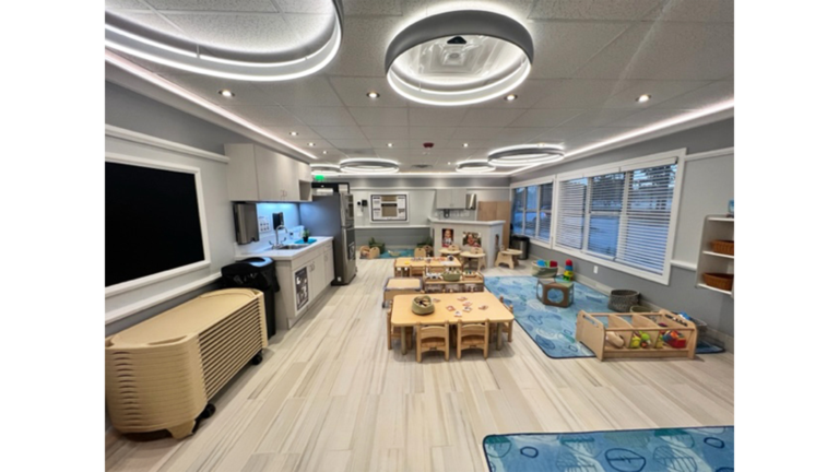 Classroom interior with child-sized tables and decorative ceiling lighting at Prescolaire Early Learning Academy Katy, Keeton Construction Services, Katy TX
