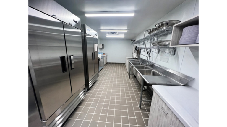 Commercial kitchen interior showing large refrigeration units and sink at Prescolaire Early Learning Academy Katy, Keeton Construction Services, Katy TX