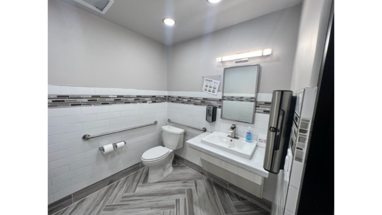 Restroom interior with grab bars, toilet, and sink at Prescolaire Early Learning Academy Katy, Keeton Construction Services, Katy TX