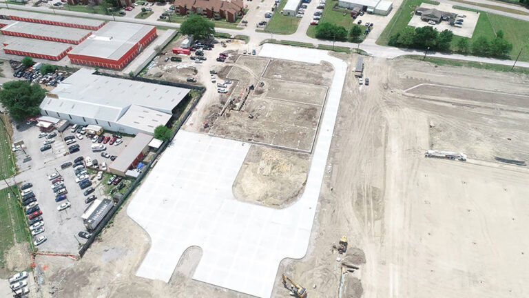 Aerial view of Gourmet Foods site work in progress in Houston, TX showing paved area and graded ground, by Keeton Construction Services