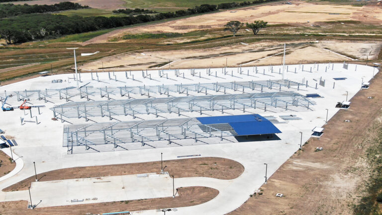 Lamar CISD Transportation Center Bus Canopies in Rosenberg TX - aerial view of canopy framing arrays on site during construction, Keeton Construction Services