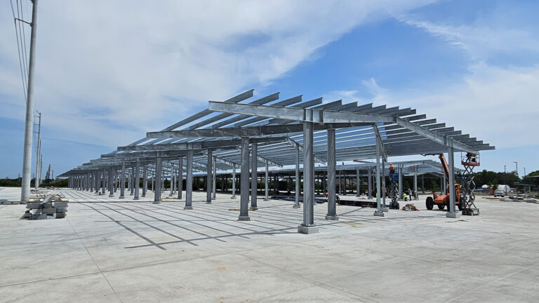 Lamar CISD Transportation Center Bus Canopies in Rosenberg TX - structural framing during construction with lift equipment, Keeton Construction Services