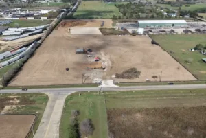 Aerial view of the Madden Bolt Corporation site in Hockley, TX during earthwork by Keeton Construction Services, showing a cleared and graded site with equipment present, manufacturing facility construction