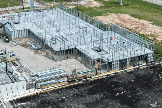H-Town Public Storage in Houston, TX - aerial view of the framed building perimeter during construction with workers on site, by Keeton Construction Services